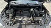 Under-hood view of a car engine bay featuring an Ecotec engine, battery, and fluid reservoirs visible.