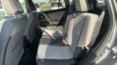 Interior view of a gray cloth SUV rear seating area with headrests and seat belts visible