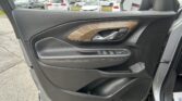Close-up of a car door interior showing window controls and woodgrain trim