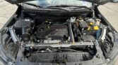 Open hood car engine bay showing ECOTEC engine and battery, air intake, and reservoir caps visible beneath wipers.