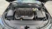 Open car hood revealing a Chevrolet V6 VVT engine with surrounding components visible.