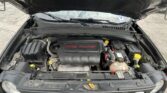 Open car hood revealing engine bay; engine cover reads '2.4L Multiair' in a dark vehicle front.