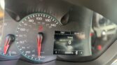 Car instrument cluster with a large speedometer (0–140 mph) and a tachometer, red needles, plus a digital display showing trip data and miles driven (92,048 mi).