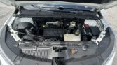 Open car hood showing engine bay with ECOTEC engine cover and visible battery components