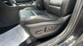 Interior of a car showing the front driver and passenger seats in black leather with a center console and gear shifter visible