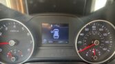 Dashboard view of a car: left tachometer, right speedometer, center display shows a top-down car icon with parking gear, outside temp 69°F, and 104,711 miles.