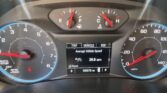 Car dashboard cluster with speedometer, tachometer, fuel and engine temperature gauges; center digital display shows trip info and 105,070 miles.