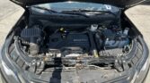 Car hood open, view of engine bay with Ecotec engine and battery visible under the hood, outdoors on pavement