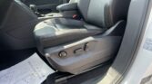 Front passenger area of a car with black leather seats, center console, gear shifter, and door panel visible