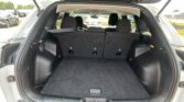 Rear cargo area of an SUV with the third-row seats upright and no items inside