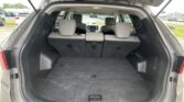 Open SUV with hatchback raised, showing an empty cargo area and upright rear seats behind the front seats in the spacious trunk.
