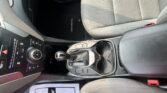 Interior of a car focusing on the front passenger seat, center console, and gear shifter; floor mat reads 'SANTA FE'.