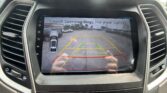 Rearview camera display with colored parking guidelines (green/yellow/red) as you back into a parking spot in a lot.