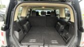 Open SUV rear hatch showing a large, empty cargo area with folded back seats and black carpeting