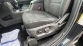 Interior of a car showing the front seat and center console, with a towel on the floor mat and the gear shifter visible