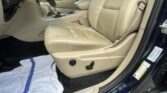 Beige leather car interior with a towel spread on the floor near the driver’s side and center console visible.
