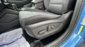 Interior of a car showing the front seats, center console, and gear shifter with a towel on the floor near the door.