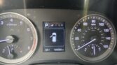 Car dashboard with speedometer and tachometer visible, gear in Park, central display showing door icon and car outline, odometer reading 105,000 miles, outside temp 68°F.