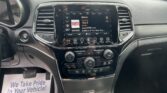 Center touchscreen in car showing radio interface (WYRK 106.5) and basic controls below.