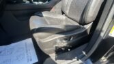 Front interior of a car showing the driver's and passenger's black leather seats and center console with controls nearby.