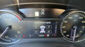 Center-dcreen cluster shows 0 MPH with tire-pressure readouts and vehicle graphic while parked; speedometer on right at 0 and left tachometer visible.
