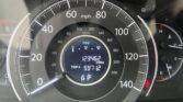 Close-up of a car dashboard showing the speedometer (0–140 mph) with the odometer reading 123,462 miles, Trip A 597.2, and outside temperature 61°F.