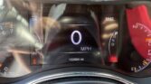 Digital car dashboard showing an active instrument cluster with 0 mph, range 156 miles, time 12:37, and odometer at 12,2004 miles; gear in Park.