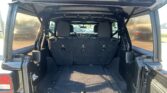Open tailgate view of a black SUV with folded third-row seats and spacious cargo area.
