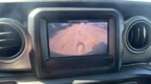 In-car display showing the rearview camera view with guiding lines for parking in a lot.