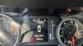 Center digital display shows a door open warning, current speed 0 mph, outside temperature 78°F, and odometer reading 66,985 miles amid the surrounding tachometer and speedometer gauges.