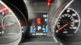 Car dashboard cluster showing speedometer and tachometer with a digital display; red warning lights and seatbelt icon visible, odometer 095224 miles.