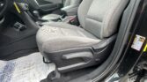 Front interior of a car showing gray fabric seats, center console, and gear shifter.