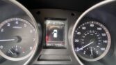 Close-up of a car dashboard showing the left tachometer and right speedometer with a central digital display indicating parking mode and a car icon, plus odometer reading 111,246 miles and outside temperature 74°F