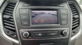 In-dash backup camera screen showing parking guide lines in a parking lot.
