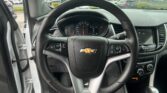 Driver's view of the dashboard from the front passenger side, steering wheel centered with Chevrolet logo and instrument cluster visible behind it.