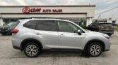 Silver SUV parked in front of the E-Z Loan Auto Sales storefront with other cars in the lot and a Toyota dealership visible in the background.