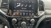 Center console touchscreen showing climate controls and decorative vents on either side.