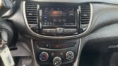 Dashboard center console with touchscreen radio displaying FM station 96.9 and show info, climate controls below.