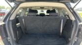 Open hatch of SUV showing empty cargo area with folded rear seats and headrests visible in the second row
