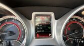 Instrument cluster with center display showing 67,768 miles and a menu list (Vehicle Speed, Trip Info, Tire PSI) while left/right gauges are visible.