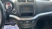 Center dashboard of a car with air vents, touchscreen showing 'Audio Off', and climate/control buttons surrounding it