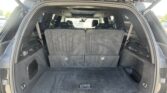 Open hatchback view of an SUV showing an empty cargo area with third-row seats upright.
