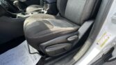 Interior of a car focusing on the front seats, center console, and gear shifter with black fabric seats and contrast stitching