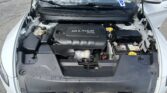 Open car hood reveals engine bay, with a black MULTIAIR 2.4L engine cover visible in a white sedan