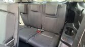 Rear row of a dark fabric SUV seats with three seating positions and visible seatbelts