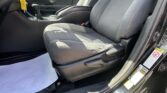 Interior of a car with front seats, center console, gear shifter, and a yellow key tag hanging from the ignition in view