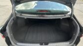 Open trunk of a black SUV showing an empty cargo area and rear window