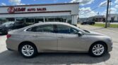 Gray Chevrolet Malibu parked in a dealership lot with the 'E-Z Loan Auto Sales' building in the background.
