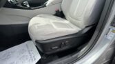 Front passenger seat and center console in a gray car interior, with gear shifter visible.