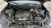 Open hood showing car engine bay with ECOTEC engine cover, battery, and various hoses and reservoirs.